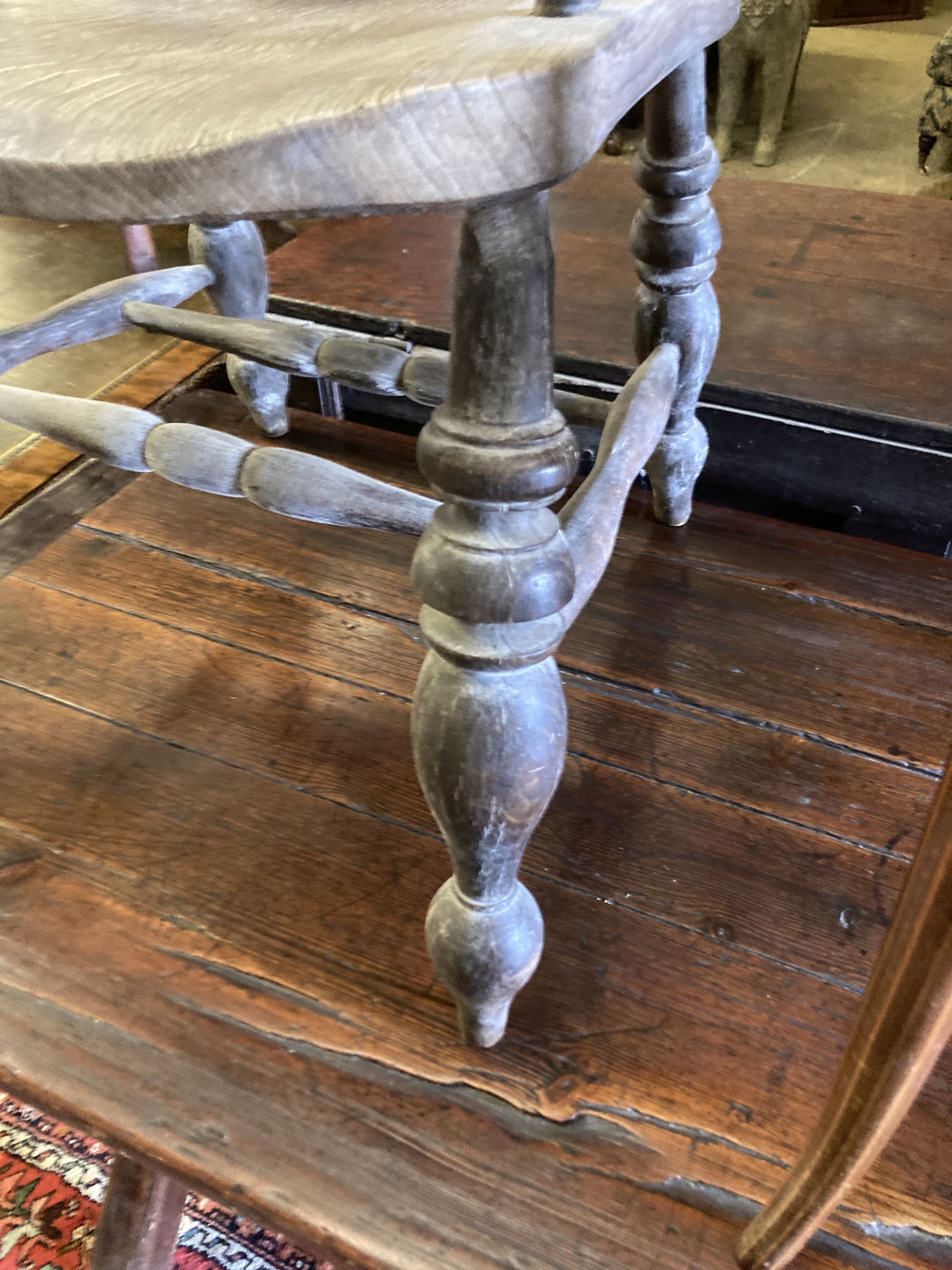 A Victorian bleached elm and ash smokers bow chair and an Edwardian inlaid mahogany elbow chair (2)